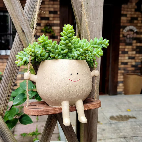 Maceta Creativa – Columpio Sonriente para Jardín y Hogar